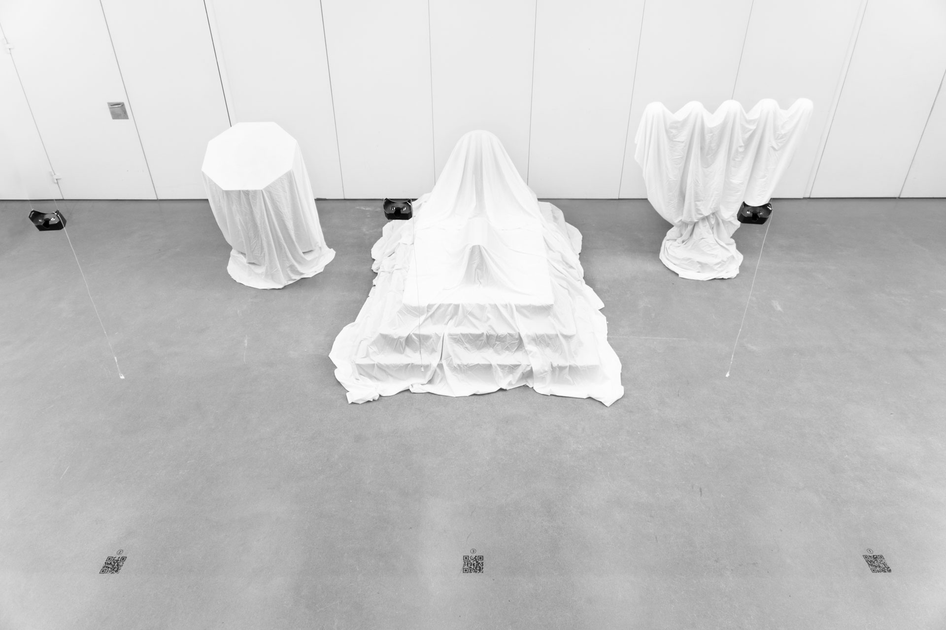 Interzone: Top view of veiled life-sized sculptures exploring human rituals and sacred aesthetics